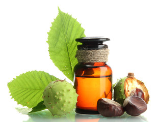 medicine bottle with chestnuts and leaves, isolated on white