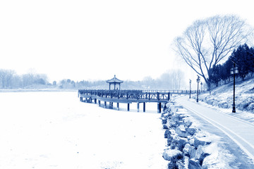 Chinese traditional style wooden bridge in the snow