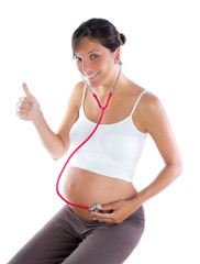 Beautiful pregnant woman as self doctor with stethoscope