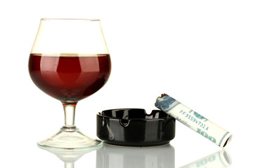 Cigar of the 100 dollar bill and an ashtray and glass of brandy