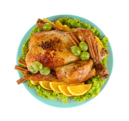 whole roasted chicken with lettuce, grapes, oranges and spices