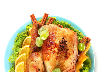 whole roasted chicken with lettuce, grapes, oranges and spices