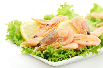 Boiled shrimps with lemon and lettuce leaves