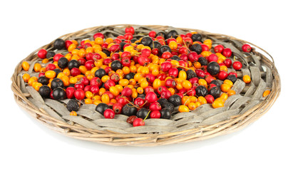colorful autumn berries on wicker mat isolated on white