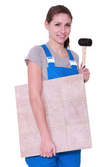 young woman holding tiles an a hammer