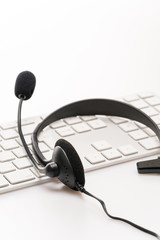 Fototapeta na wymiar Office headset with microphone keyboard on desk