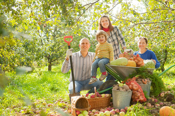 Happy  family with  harvest in garden