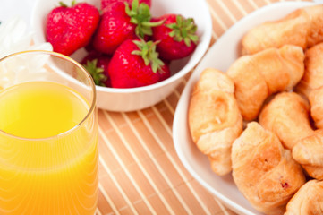 Breakfast with berries,orange juice and croissant
