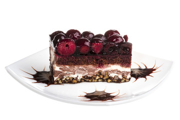 Chocolate cake with cherry on top on a white background