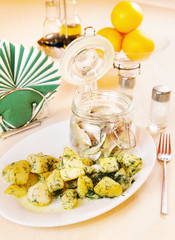 Boiled potatoes with salted herrin on a plate