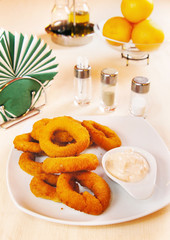 Onion rings fried in batter with sauce