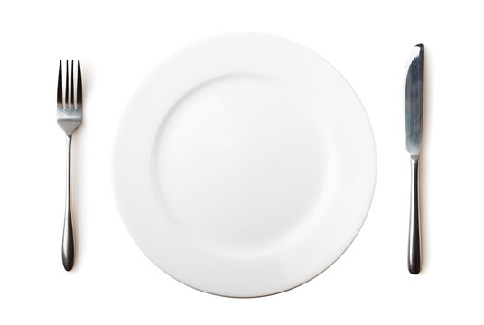 Empty plate, fork and knife - isolated over white