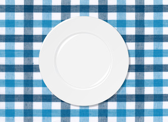 White plate on blue and white tablecloth