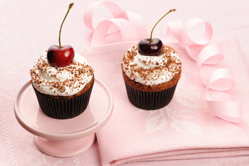 Cupcakes with whipped cream and cherry
