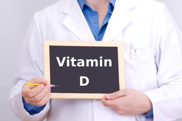 Doctor shows information on blackboard: vitamin d