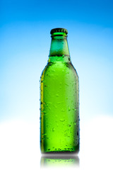 green beer bottle on blue background