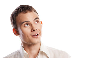 Fototapeta premium Handsome smiling young man looking up isolated