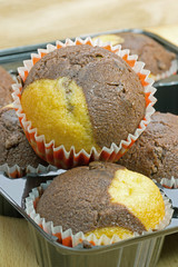 Chocolate and vanilla muffins in paper cake cups
