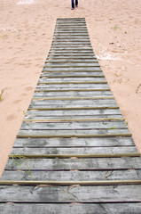 Obraz premium wooden bridge on sand in sea beach