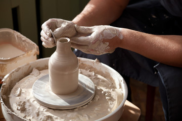 Pottery masterclass. Hands with throwing wheel