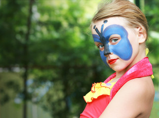Portrait of a girl with painted blue Butterfly mask
