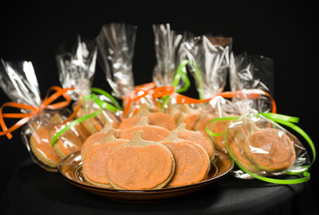 Homemade pumpkin cookies on isolated black