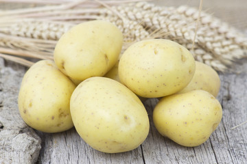 potatoes on old wooden background