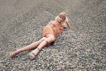 Young woman outdoors portrait in a quarry. Full body.