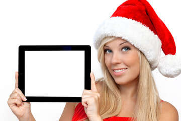 girl in a red Christmas hat on New Year, holding tablet touch pa