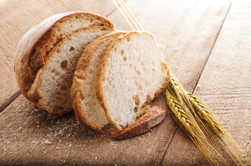 sliced bread and wheat on the wooden table