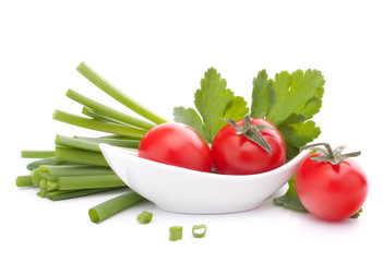 Spring onions and cherry tomato in bowl