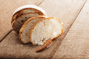 sliced bread and wheat on the wooden table