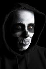 Scary skeleton on black background