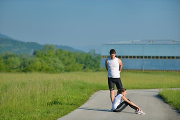 people doing stretching exercise  after jogging