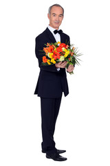 elegant senior man with a flowers bouquet