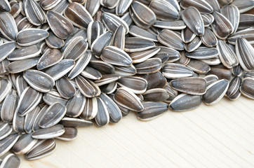 Grains of sunflower seed on wood background