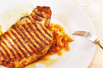 Pork chop with boiled potatoes and cabbage