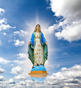 Virgin mary statue at the sky background.