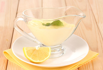 Mayonnaise in bowl on wooden table