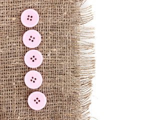 Colorful sewing buttons on sackcloth