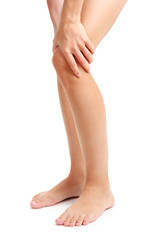 woman holding sore leg, isolated on white
