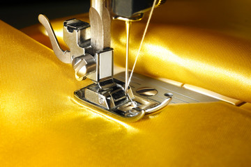 Sewing machine with gold cloth closeup
