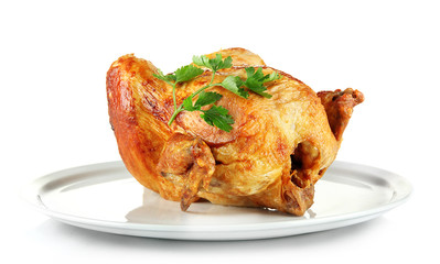 Roasted whole chicken on a white plate isolated on white