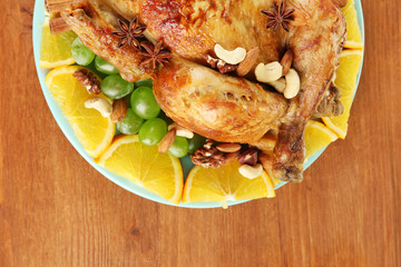 whole roasted chicken with grapes, oranges and spices