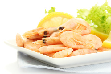 Boiled shrimps with lemon and lettuce leaves