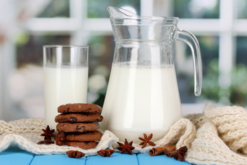 Pitcher and glass of milk with cookies