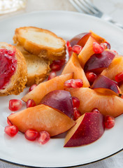 Breakfast toasts with jam, plum and pomegranate seeds