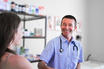 Smiling Male Doctor Helping Woman