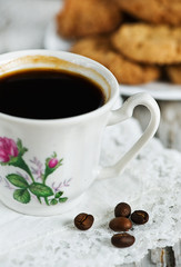 Cup of coffee, cookies and coffee beans