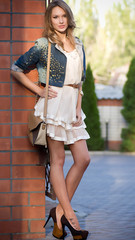 Obraz premium Beautiful young woman in fashion clothes